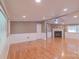 Spacious living room with hardwood flooring, brick fireplace, and abundant natural light at 6813 Rebel Rd, Marshville, NC 28103