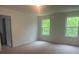 Bright bedroom with two windows and neutral carpet with an open door to the left at 756 Gondola Ct # 127, Salisbury, NC 28144
