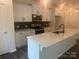 Bright, open kitchen with white cabinets, stainless steel appliances, and center island at 756 Gondola Ct # 127, Salisbury, NC 28144