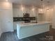 Bright, open kitchen with white cabinets, stainless steel appliances, and center island at 756 Gondola Ct # 127, Salisbury, NC 28144