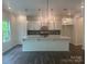 Bright, open kitchen with white cabinets, stainless steel appliances, and center island at 756 Gondola Ct # 127, Salisbury, NC 28144