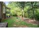 Private backyard featuring a stone bench, fire pit, and wooded surround at 8300 Loma Linda Ln, Waxhaw, NC 28173