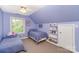 A bedroom with blue walls and carpet, two twin beds, window, and a ceiling fan offers a cozy retreat at 8300 Loma Linda Ln, Waxhaw, NC 28173