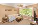 Cozy bedroom featuring a large window, beige walls, and a ceiling fan perfect for relaxation at 8300 Loma Linda Ln, Waxhaw, NC 28173