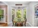 Bright breakfast nook with bay window, light fixture, and seating for four creates a cozy dining space at 8300 Loma Linda Ln, Waxhaw, NC 28173