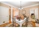 The dining room features dark wood floors and column accents, adding sophistication at 8300 Loma Linda Ln, Waxhaw, NC 28173