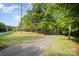 Long driveway winding through lush greenery, providing privacy and seclusion at 8300 Loma Linda Ln, Waxhaw, NC 28173