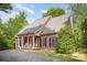 Brick home with a inviting front porch, black shutters, and well-maintained landscaping at 8300 Loma Linda Ln, Waxhaw, NC 28173