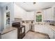 Bright kitchen features white cabinets, tiled floors, stainless steel appliances, and lots of natural light at 8300 Loma Linda Ln, Waxhaw, NC 28173