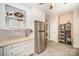 Kitchen with white cabinets, stainless steel refrigerator, and adjacent shelving at 8300 Loma Linda Ln, Waxhaw, NC 28173