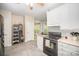Open kitchen space with stainless steel refrigerator, white cabinets, and tiled floors at 8300 Loma Linda Ln, Waxhaw, NC 28173