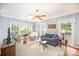 Bright living room with large windows, ceiling fan, and a comfortable seating arrangement at 8300 Loma Linda Ln, Waxhaw, NC 28173