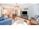 Open living area with hardwood floors, ceiling fan, and a staircase visible in the background at 8300 Loma Linda Ln, Waxhaw, NC 28173