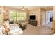 Neutral Gathering room features a window, tv, and door offering a comfortable and well-lit living space at 8300 Loma Linda Ln, Waxhaw, NC 28173