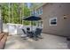 An outdoor patio includes a dining set with an umbrella, and views of the house and surrounding trees at 836 Meadowlark Dr, Rock Hill, SC 29732