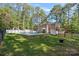Backyard with a pool, patio seating, mature trees, and lush green grass at 836 Meadowlark Dr, Rock Hill, SC 29732
