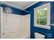 Bathroom featuring a shower-tub combo and a window to the backyard at 836 Meadowlark Dr, Rock Hill, SC 29732