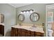 Bathroom featuring double sinks with an ornate vanity and matching mirrors at 836 Meadowlark Dr, Rock Hill, SC 29732