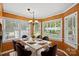 Dining room with a modern light fixture, white table and six chairs and large windows at 836 Meadowlark Dr, Rock Hill, SC 29732