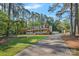 Serene two-story home surrounded by mature trees and a lush lawn, featuring a spacious front porch at 836 Meadowlark Dr, Rock Hill, SC 29732