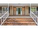 Charming home entrance with brick steps and white-railed porch, flanked by shuttered windows and sconce lighting at 836 Meadowlark Dr, Rock Hill, SC 29732