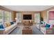 Bright living room featuring a large flat-screen TV, comfortable seating, and natural light from windows at 836 Meadowlark Dr, Rock Hill, SC 29732