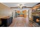 Large open-concept living area featuring a brick fireplace, wood beam, and access to the kitchen at 836 Meadowlark Dr, Rock Hill, SC 29732
