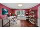 Bright office with a modern desk setup, stylish shelving, and cherry colored walls at 836 Meadowlark Dr, Rock Hill, SC 29732