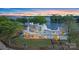 Aerial view of stately home with a pool, manicured lawn, mature trees, and lake access at 8397 Ranger Island Marina Rd, Denver, NC 28037