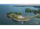 Aerial view of a lakefront estate with mature trees, docks, and manicured lawns at 8397 Ranger Island Marina Rd, Denver, NC 28037