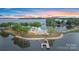 Aerial view of an exclusive waterfront property with beautiful landscaping and a dock at 8397 Ranger Island Marina Rd, Denver, NC 28037