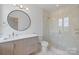 Modern bathroom featuring a glass shower stall and a vanity with a round mirror at 8397 Ranger Island Marina Rd, Denver, NC 28037
