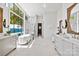 Luxurious bathroom featuring a freestanding tub, glass shower, and large windows with scenic water views at 8397 Ranger Island Marina Rd, Denver, NC 28037