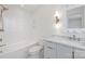 This bathroom features a tub/shower combo, white tiling and a modern vanity at 8397 Ranger Island Marina Rd, Denver, NC 28037