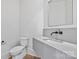 Contemporary powder room with sleek fixtures, modern sink, and minimalist design for a clean aesthetic at 8397 Ranger Island Marina Rd, Denver, NC 28037