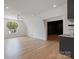 Bonus room featuring hardwood floors, modern lighting, a ceiling fan, and arched window at 8397 Ranger Island Marina Rd, Denver, NC 28037