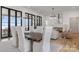 Open dining room with modern chandelier, fireplace and lake view at 8397 Ranger Island Marina Rd, Denver, NC 28037