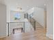 Bright hallway featuring hardwood floors, black metal stair railing, and a large window with lake views at 8397 Ranger Island Marina Rd, Denver, NC 28037