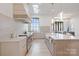 Bright kitchen features an island, stainless steel appliances, stone countertops, and large windows at 8397 Ranger Island Marina Rd, Denver, NC 28037