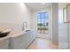 Functional laundry room featuring a sink, cabinetry, and a large window with lake view at 8397 Ranger Island Marina Rd, Denver, NC 28037