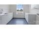 Laundry room featuring shaker cabinets, countertops and black tile floors and lake views at 8397 Ranger Island Marina Rd, Denver, NC 28037