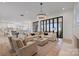Spacious living room with hardwood floors, floor-to-ceiling windows, and an elegant chandelier at 8397 Ranger Island Marina Rd, Denver, NC 28037