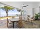 Covered outdoor patio features a ceiling fan, fireplace, dining table, and lake view at 8397 Ranger Island Marina Rd, Denver, NC 28037