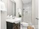 A full bathroom with white marble tiling in the walk-in shower, dark wood vanity and gray walls at 908 W Airline Ave, Gastonia, NC 28052