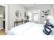 Bright bedroom featuring large windows, a round mirror and minimal, modern decor at 908 W Airline Ave, Gastonia, NC 28052
