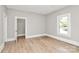 An empty bedroom features wood-look floors, neutral paint and white trim at 908 W Airline Ave, Gastonia, NC 28052