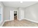 Inviting bedroom with hardwood floors, open doorway, and white trim at 908 W Airline Ave, Gastonia, NC 28052