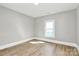Cozy bedroom with a window offering natural light and wood-look floors at 908 W Airline Ave, Gastonia, NC 28052
