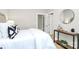 Light bedroom with stylish décor, including decorative pillows and side table at 908 W Airline Ave, Gastonia, NC 28052