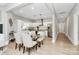 Bright dining area featuring hardwood floors, a glass table, and open access to the modern kitchen at 908 W Airline Ave, Gastonia, NC 28052